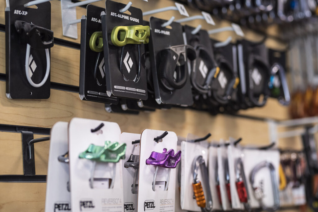 Photo of Inner Peaks retail display featuring ATC devices and carabiners. As a member, you receive 10% off our retail selection, including these items. Click to visit our Gear Shop page and start shopping now. 
